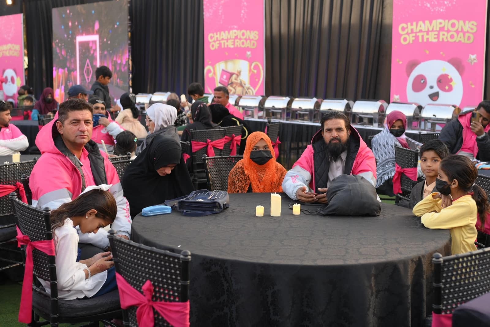 Foodpanda riders and families at community event in Pakistan